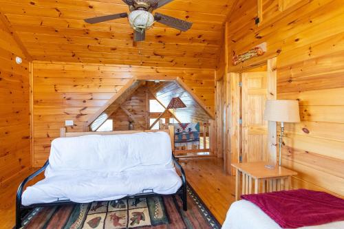 a room with a chair in a log cabin at Climber's Haven in Rogers