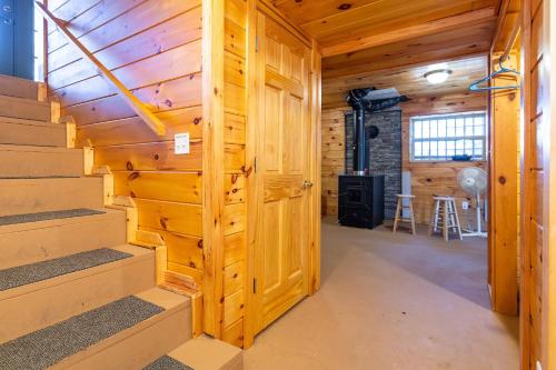 a room with stairs in a log cabin at Climber's Haven in Rogers