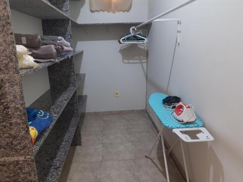 a walk in shower in a room with a shelf at Casa Da Vovó Helena in Vila Velha