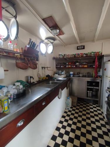 a kitchen with a sink and a checkered floor at Jacob in Ribeira da Barca