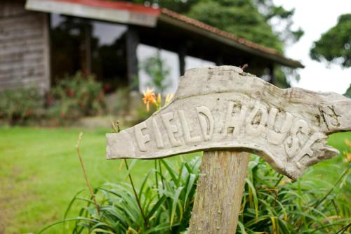a stone sign in front of a house at Poas Volcano Lodge in Vara Blanca