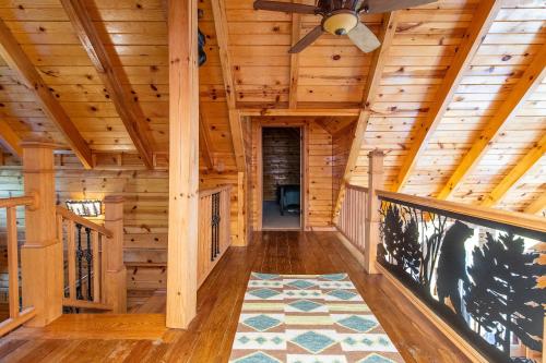a hallway in a log cabin with a ceiling fan at Mill Creek Point in Rogers