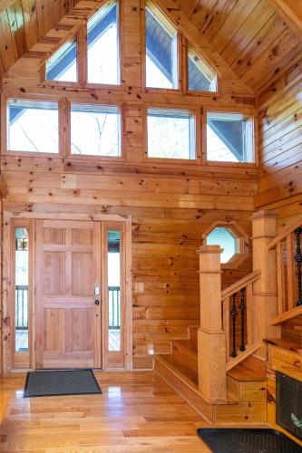 a large wooden room with a door and windows at Mill Creek Point in Rogers