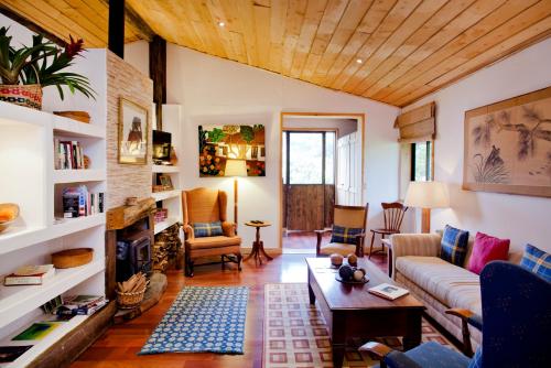 a living room with a couch and a table at Poas Volcano Lodge in Vara Blanca