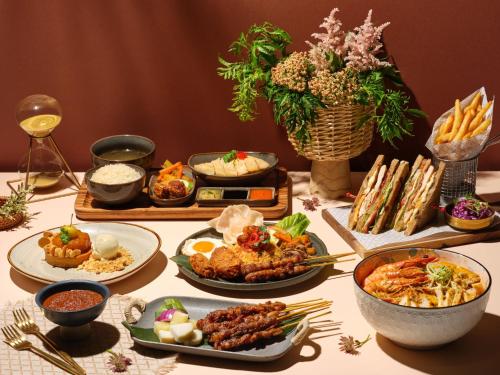 a table with plates of food on a table at InterContinental Singapore by IHG in Singapore