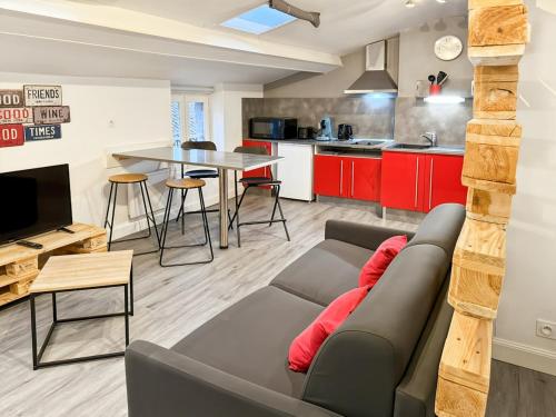a living room with a couch and a table at Appartement cosy cœur d'Aurillac, 2 lits, Wifi in Aurillac