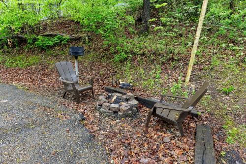 two chairs and a fire pit next to the road at Romantic Hideaway in Rogers