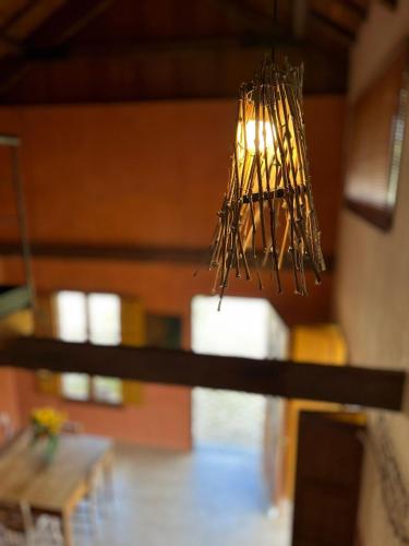 a chandelier hanging from the ceiling in a room at Pousada Borghetto – Charme e Exclusividade no Vale dos Vinhedos in Bento Gonçalves