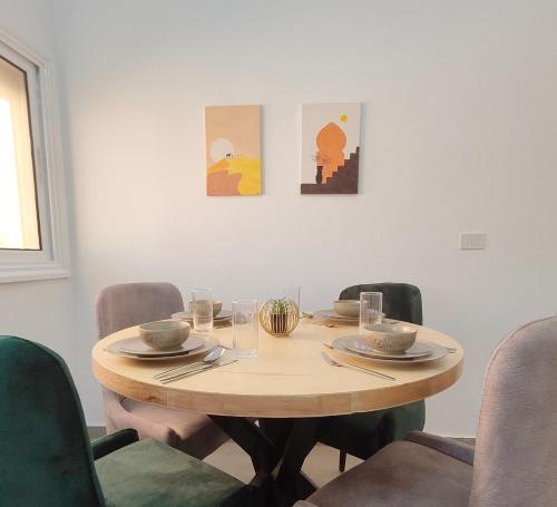 a table in a room with chairs around it at Oasis Apartment in Safaga 