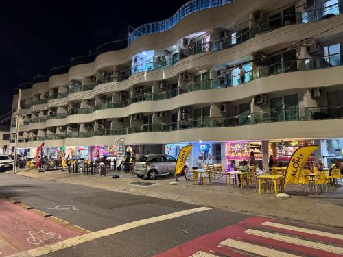 a building with tables and chairs in front of a street at APART HOTEL MANAÍRA PALACE in João Pessoa