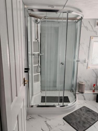 a shower with a glass door in a bathroom at Dog Friendly 8 Berth Lodge, 600 Yard's From The Beach In Hunstanton in Hunstanton