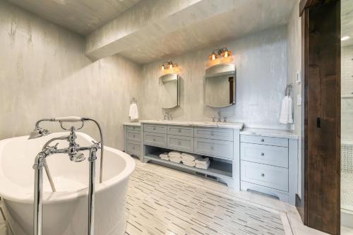 a bathroom with a tub and two sinks and a bath tub at Aqua Vista Lakefront Estate by Tahoe Getaways - 6 BR in Carnelian Bay w Buoy, Pier & Game Room in Carnelian Bay