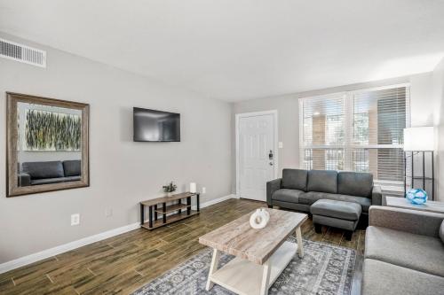 a living room with a couch and a table at Towne Plaza Apartments 104 - 7 km from FIFA Fest in Houston