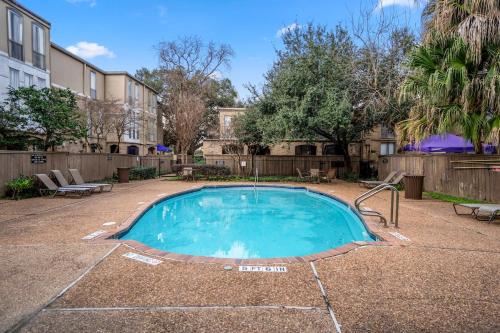 a swimming pool in a yard with a fence at Towne Plaza Apartments 104 - 7 km from FIFA Fest in Houston