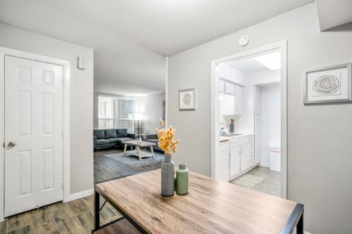 a living room with a wooden table and a kitchen at Towne Plaza Apartments 104 - 7 km from FIFA Fest in Houston