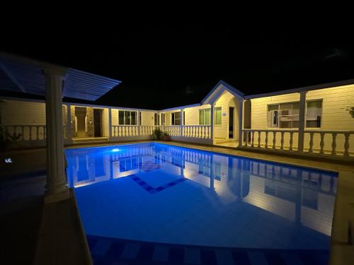 a swimming pool lit up at night at Casa en Girardot in Ricaurte