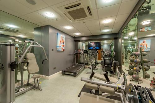 a gym with treadmills and machines in a room at Mercure Nottingham City Centre Hotel in Nottingham