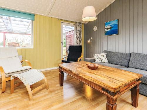 a living room with a table and a couch at 4 person holiday home in Vordingborg-By Traum in Vordingborg