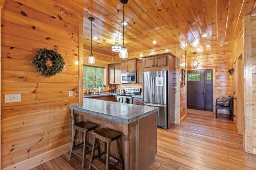 a kitchen with wooden walls and a wooden floor at Sky Pointe in Rogers