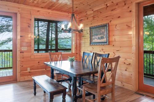 a dining room with a wooden table and chairs at Sky Pointe in Rogers