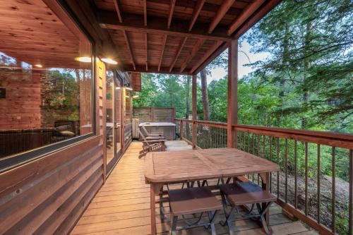 a wooden deck with a wooden table and chairs at Sky Pointe in Rogers