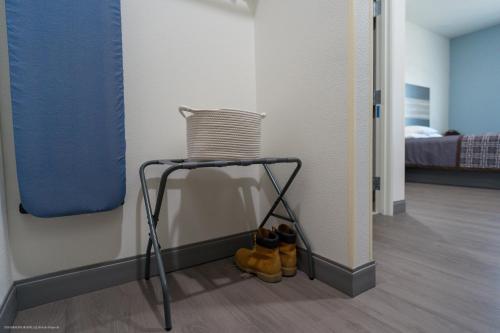 a chair sitting in a room with shoes under it at Texas Bungalows Hotel & Hotel Que at Lakeline Austin Cedar Park in Cedar Park
