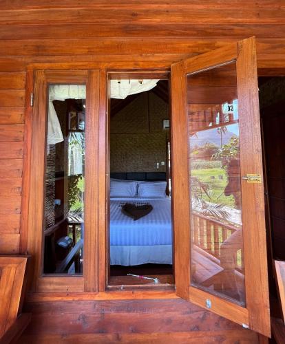 a room with a bed inside of a house at Mio Villa Tomang Omang Lombok in Selong Belanak