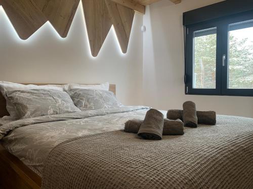 a bedroom with a bed with two stuffed animals on it at Pine Chalet Vodice in Vodice