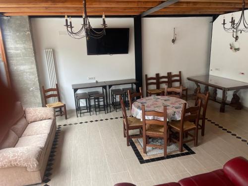 a living room with a table and chairs and a tv at TENUTA BORGATO MORELLI in Este