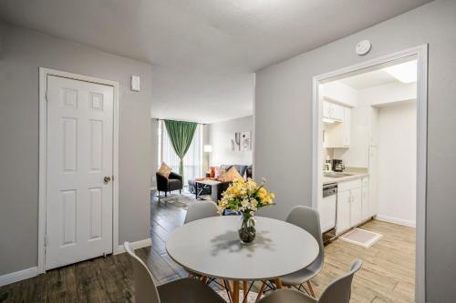 a dining room with a table and chairs and a kitchen at Towne Plaza Apartments 114 - 7 km from FIFA Fest in Houston