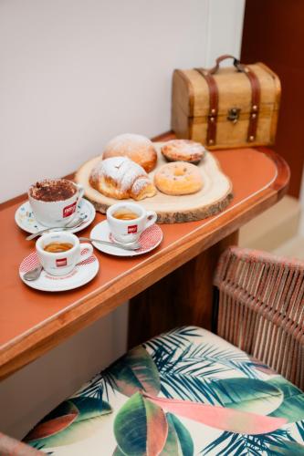 a tray of donuts and cups of coffee on a table at Four Points Suites in Naples