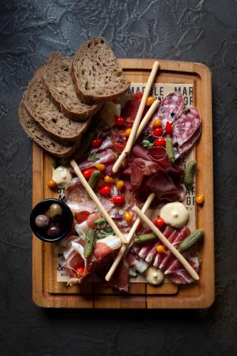 a plate of food with meat and bread and vegetables at Avenue Hotel Canberra in Canberra