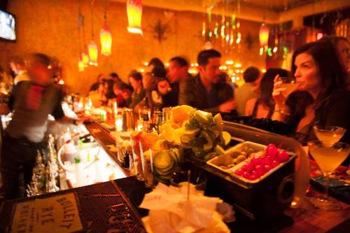 a group of people sitting at a bar in a restaurant at Queen Anne Abode - 1 Block from CPA! - Free Parking! in Seattle