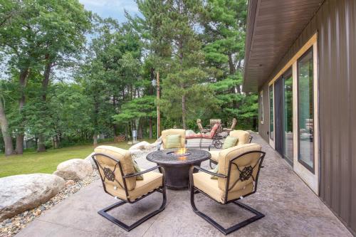 a patio with a table and chairs on a porch at Lakefront Home with Private Dock about 15 Mi to Walker in Walker