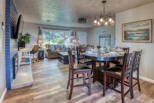 a dining room and living room with a table and chairs at The Pacific Lookout Sleeps 6, Hot Tub, Pet Friendly, Ocean View, EV Charger in Lincoln City