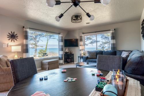 a living room with a couch and a table at The Pacific Lookout Sleeps 6, Hot Tub, Pet Friendly, Ocean View, EV Charger in Lincoln City