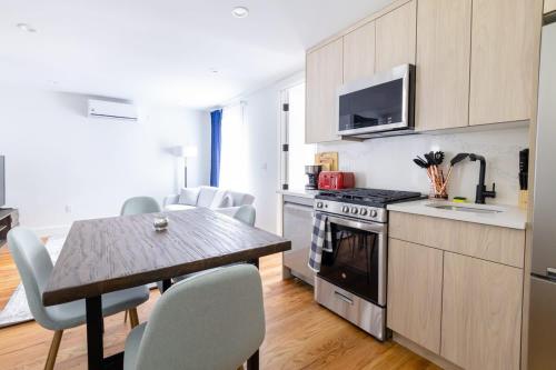 a kitchen with a table and a dining room at 323-2 Spacious 2BR Williamsburg in Brooklyn