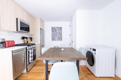 a kitchen with a wooden table and a microwave at 323-2 Spacious 2BR Williamsburg in Brooklyn