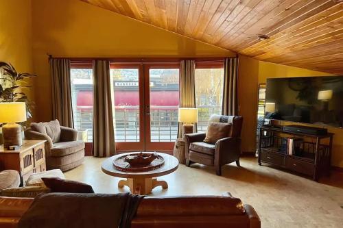 a living room with a couch and a table at Sqc Downtown Retreat in Sequim