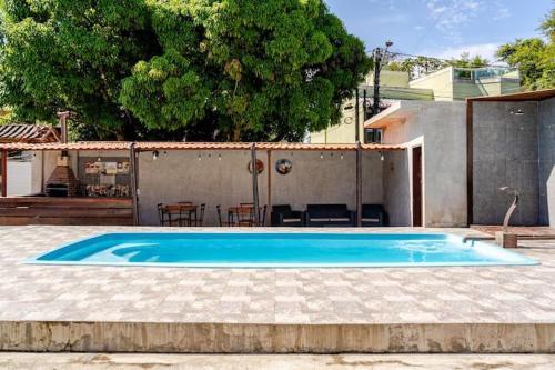 a large blue swimming pool in a yard at Royal Bela Vista in Rio das Ostras