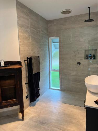 a bathroom with a sink and a toilet and a shower at Yarra Fox Farm Cottage Farmstay in Dixons Creek