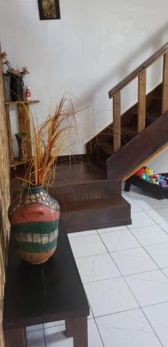 a vase sitting on a table next to a staircase at Papaya Wildlife Lodge in Cahuita