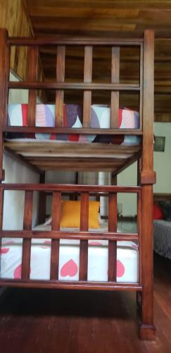a wooden bunk bed with a yellow pillow on it at Papaya Wildlife Lodge in Cahuita