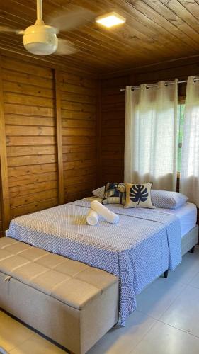 a bedroom with two beds in a wooden room at Chalés nas Montanhas in Domingos Martins