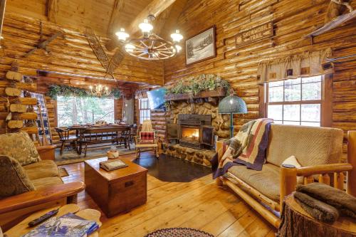 a living room with a fireplace in a log cabin at Lake and Beach Access at Lake Luzerne Cabin! in Lake Luzerne