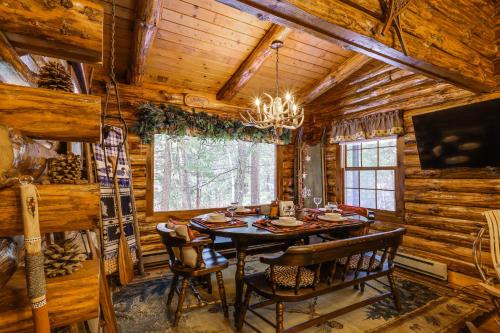 a dining room in a log cabin with a table and chairs at Lake and Beach Access at Lake Luzerne Cabin! in Lake Luzerne