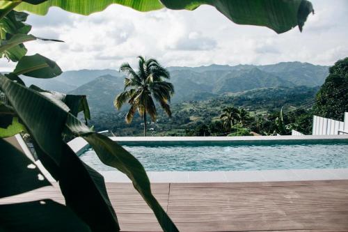 a view of a swimming pool with mountains in the background at Hideout sa Babag in Cebu City