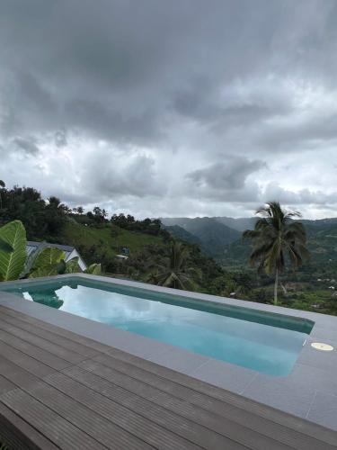 a swimming pool with a view of the mountains at Hideout sa Babag in Cebu City