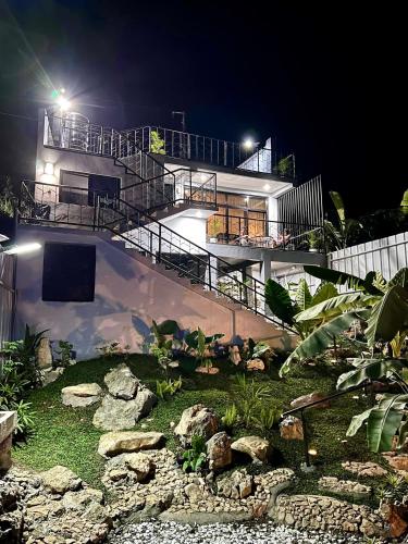 a house at night with a garden in front of it at Hideout sa Babag in Cebu City