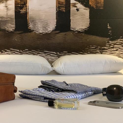 a table with a phone and a watch and pillows at ibis Chia in Chía
